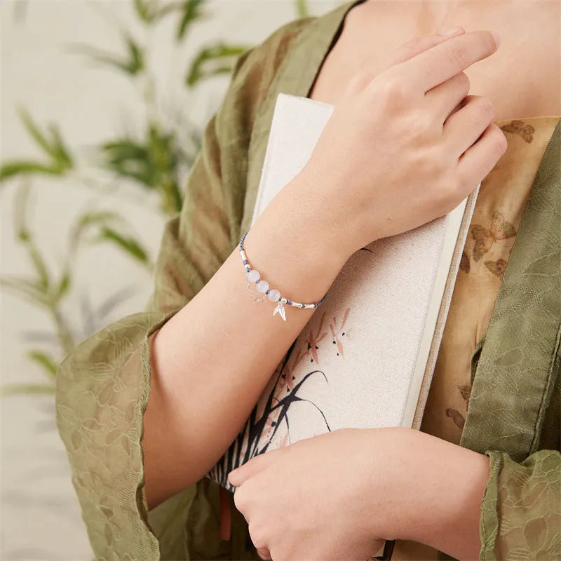 Women's Hetian jade bracelet with woven strap, diamond beads, and lotus seedpod charm in light green or haze blue