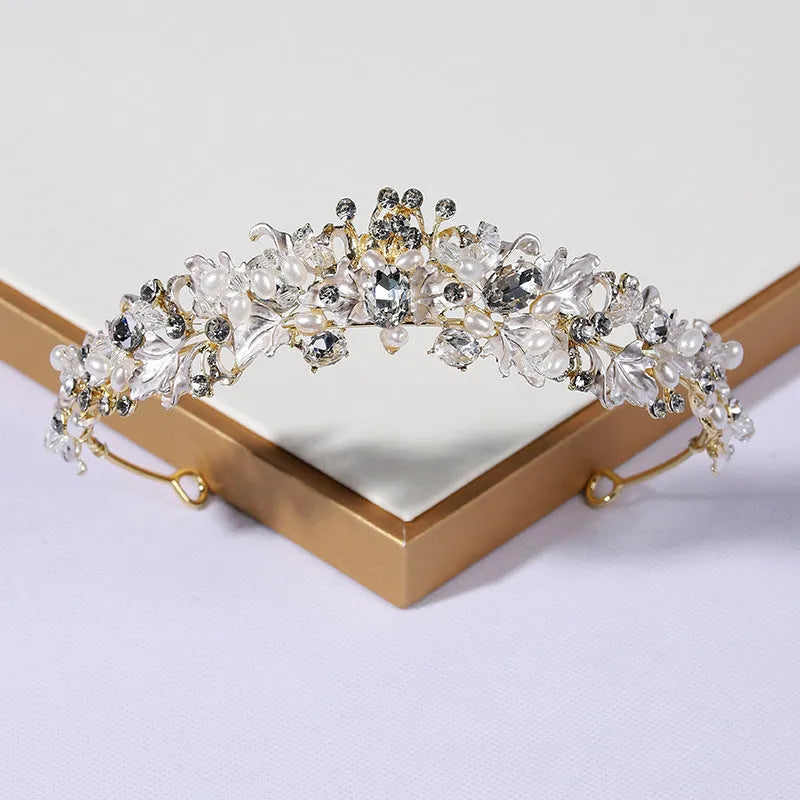 Gold and silver alloy pearl crown headdress hair accessory for women on a white background.