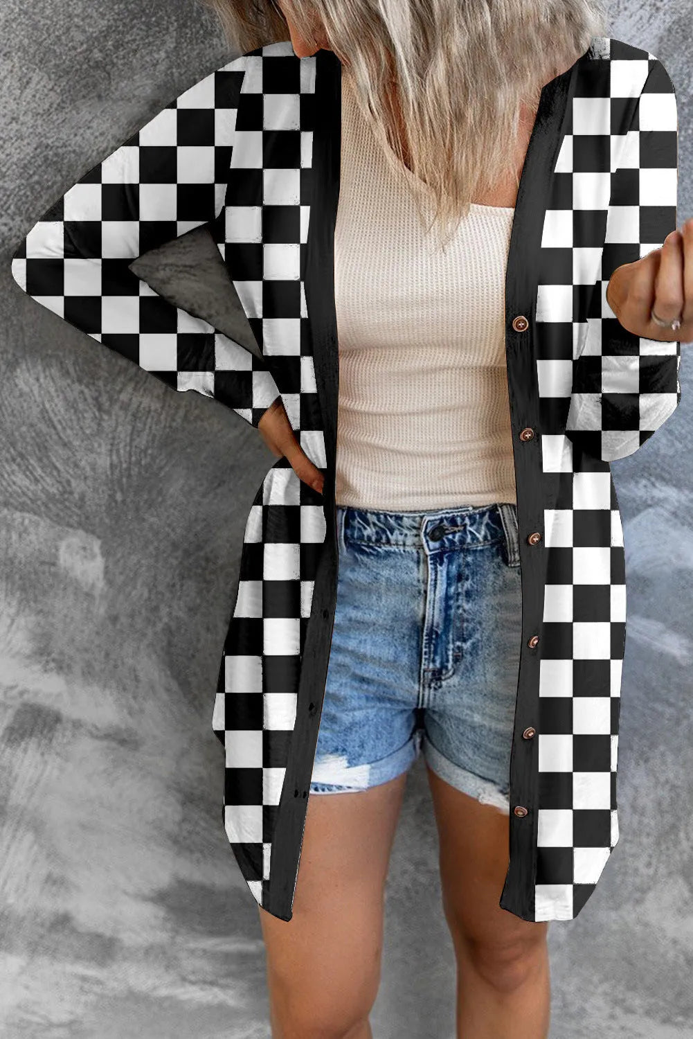 Women's long grey plaid knitted cardigan coat with a loose fit and regular sleeves on a hanger.