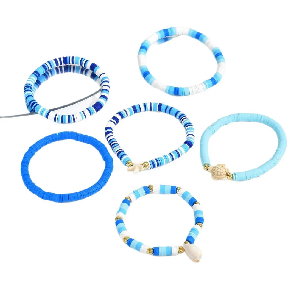 Six handmade polymer clay bracelets with geometric shapes and shell decorations in bohemian blue S3162 colour