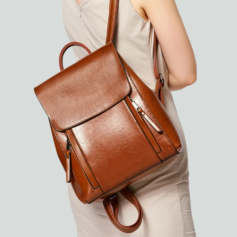 Women's genuine leather backpack in black with stitching details and multiple internal pockets