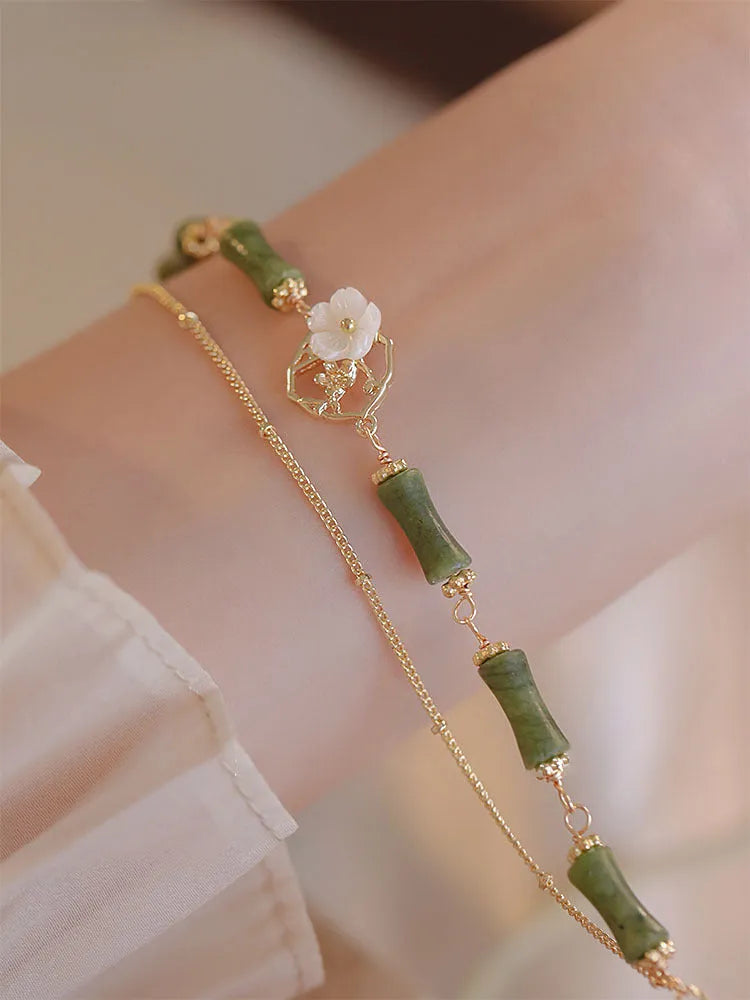 Natural olivine bracelet with double layer design featuring twin bells and olive branch motif