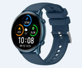 Round black smart sports watch with full touch screen and silicone strap on a wrist.