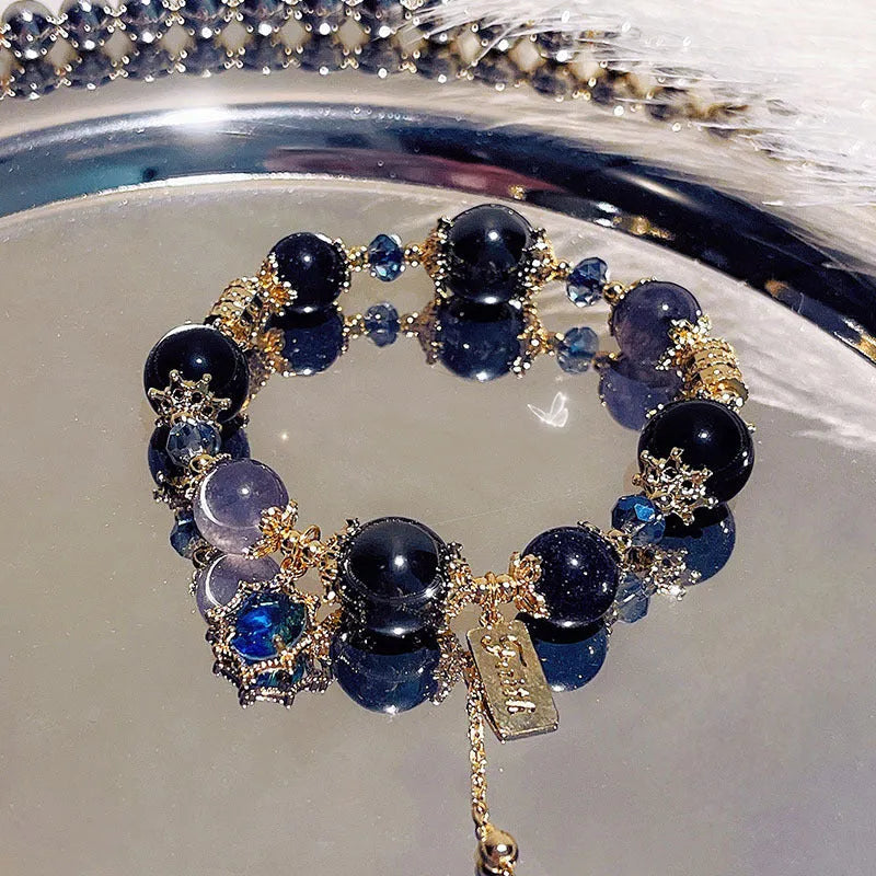 Galaxy-coloured women's alloy bracelet with snowflake pendant and bow charm.