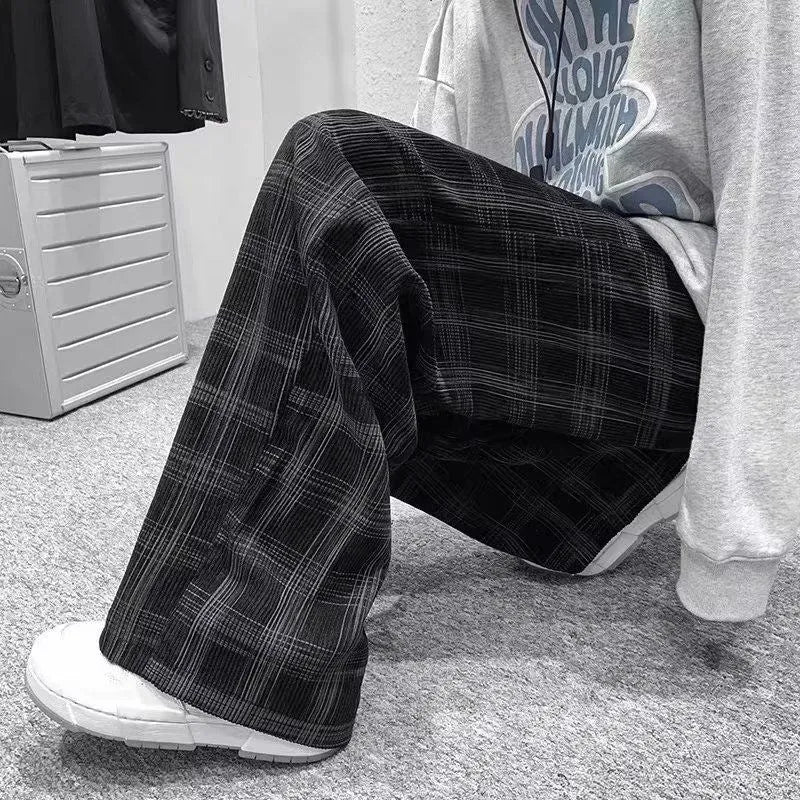 Men's black and green plaid trousers with straight leg design and mid-rise waistband