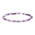 Purple natural stone elastic bead bracelet with geometric beads on a black background.
