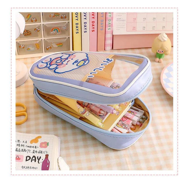 Transparent PVC pencil case with cartoon design showing pens and pencils inside