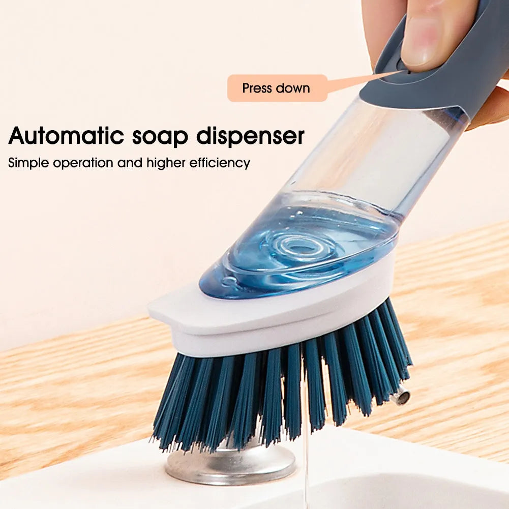 Long handled kitchen cleaning brush with a soap dispenser button and a stainless steel scouring block.