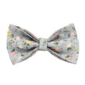 Blue floral pattern dog collar set with matching leash, vest, bow, and poop bag holder on wooden background