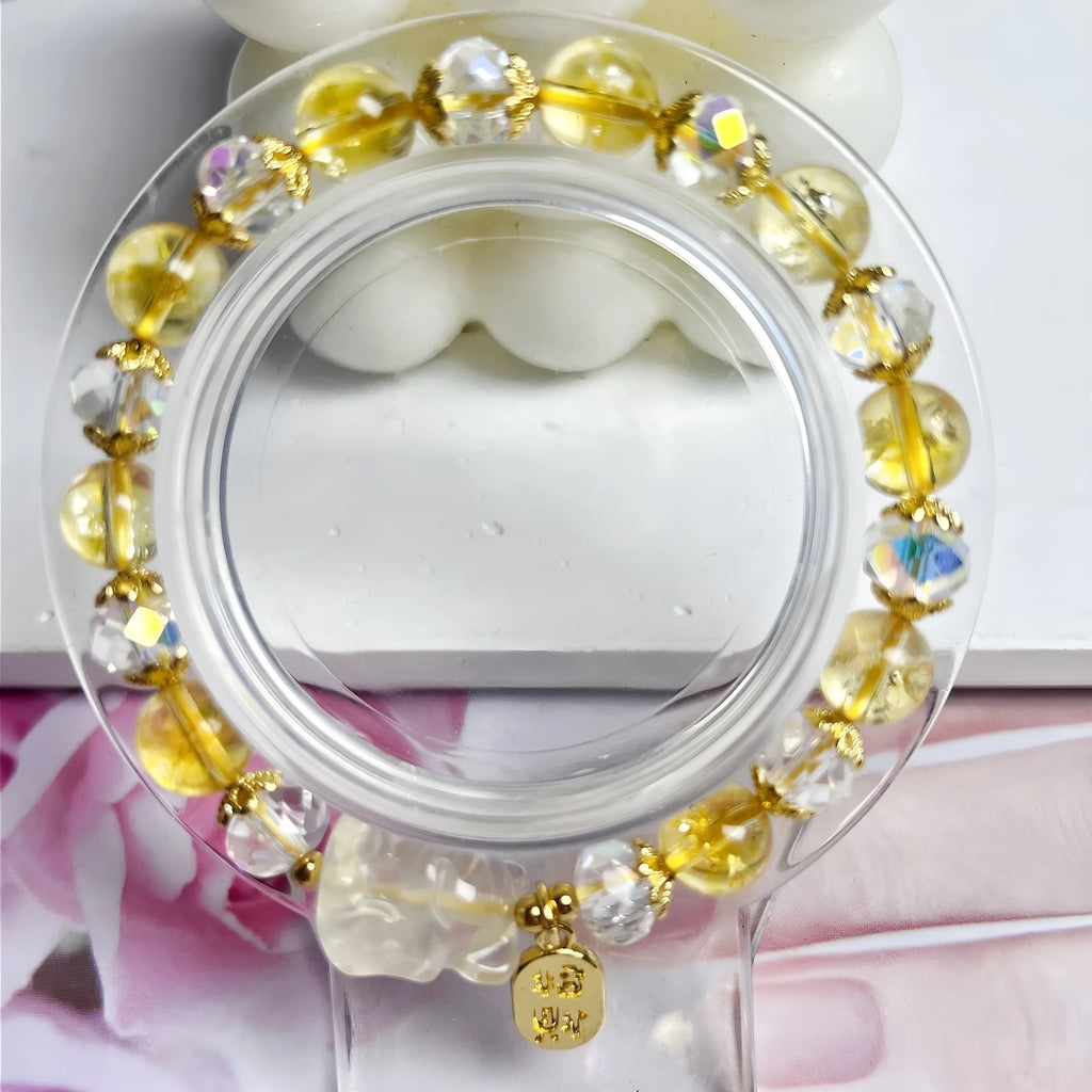 Close-up of an adjustable natural citrine crystal bracelet featuring a handcrafted nine-tail fox design on a white background.