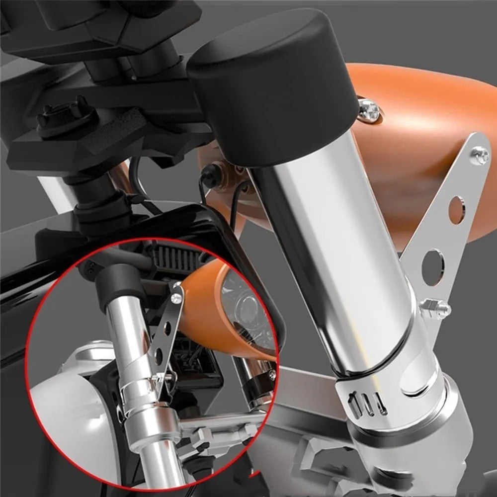 A pair of black iron motorcycle headlamp support brackets for retro modification.