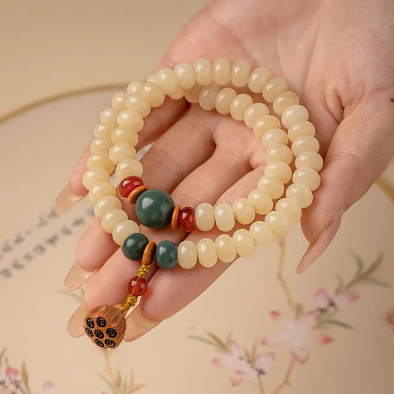 Cream topaz wooden bodhi root bracelet with 6x9mm flat round beads on wrist
