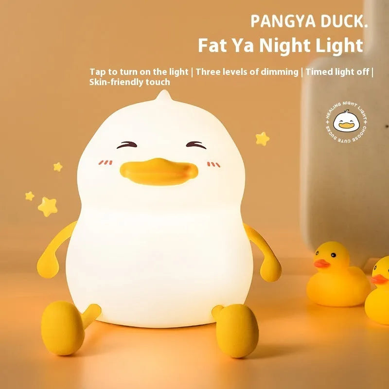 Chubby Night Light TW-L73 on desk showing silicone phone holder with mobile device and adjustable brightness settings