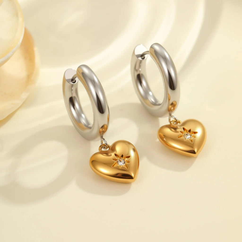 A pair of stainless steel Christmas tree and heart shaped earrings with 18K gold electroplating.