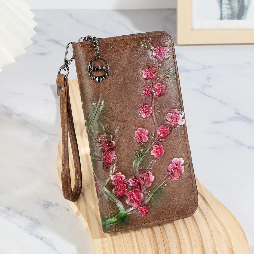 Embossed and hand-painted floral pattern on a brown Chinese-style zipper handbag.