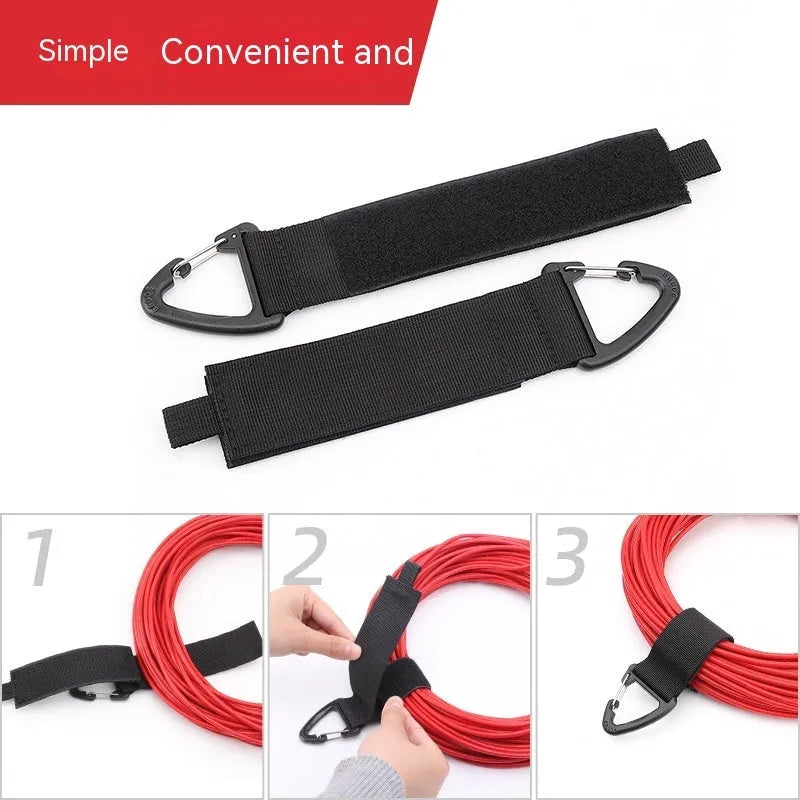 Black gravity storage strap with metal carabiner hook for workshop and camper organisation