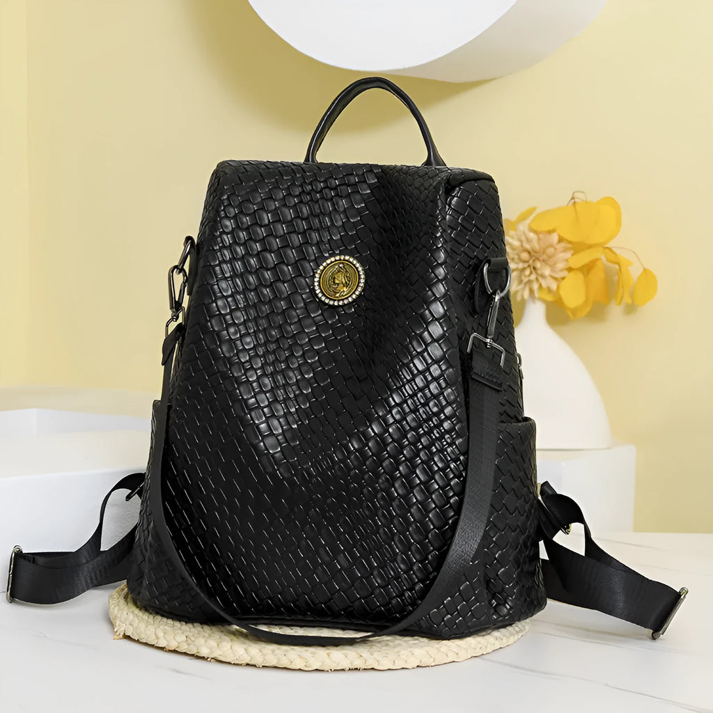 Women's black waterproof anti-theft backpack showing woven detailing and organisational compartments
