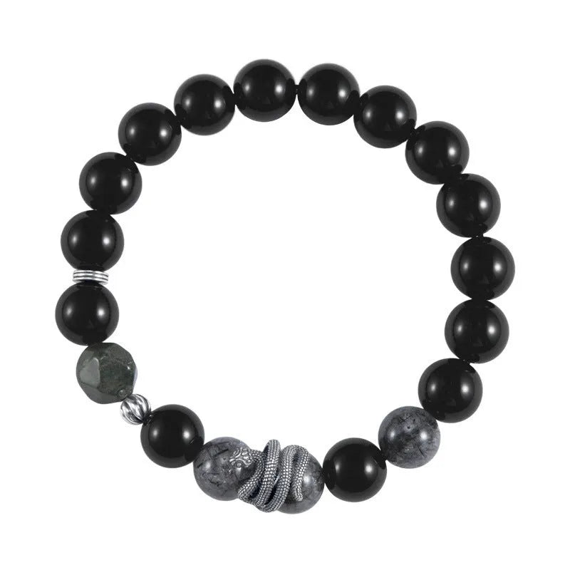 Men's retro snake bracelet in sterling silver with a large black obsidian stone on a dark background.