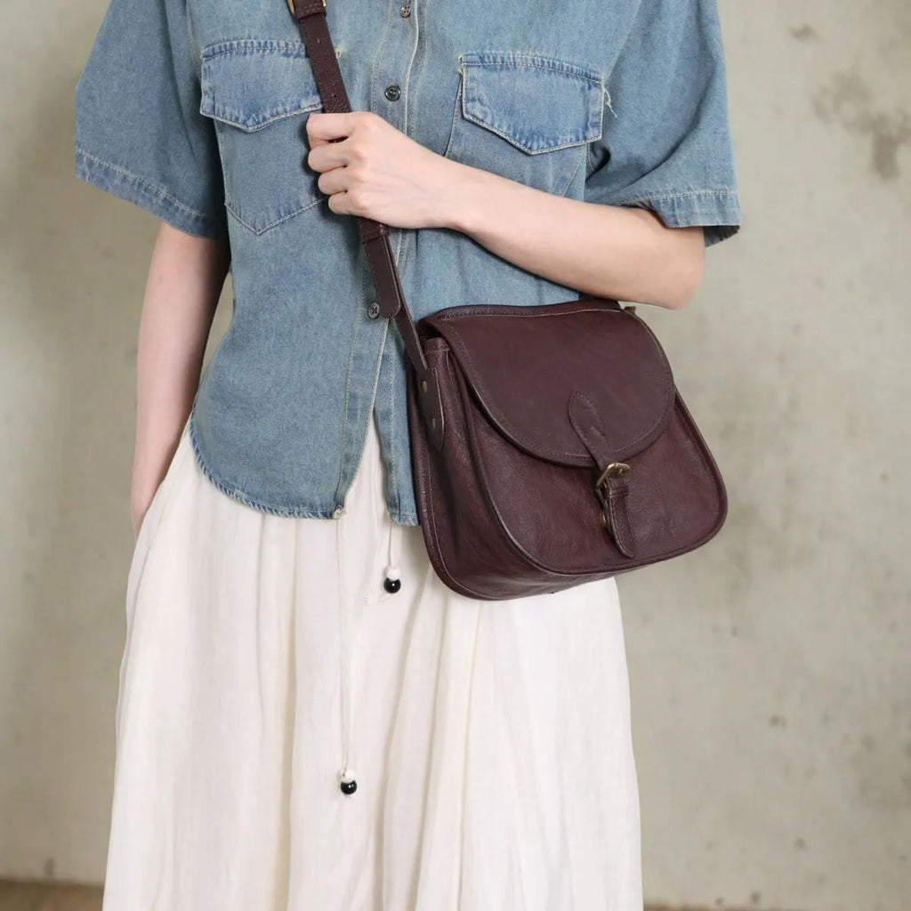 Brown retro-style genuine leather messenger bag with flap closure and crossbody strap