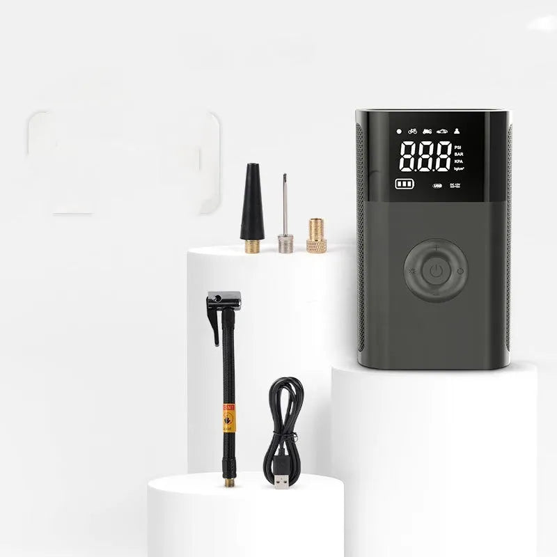 Wireless handheld digital display air pump with LCD screen showing tyre pressure, three nozzles, and charging cable