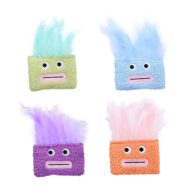Colourful cat plush toy with a funny big mouth explosion head shape on a plain background.