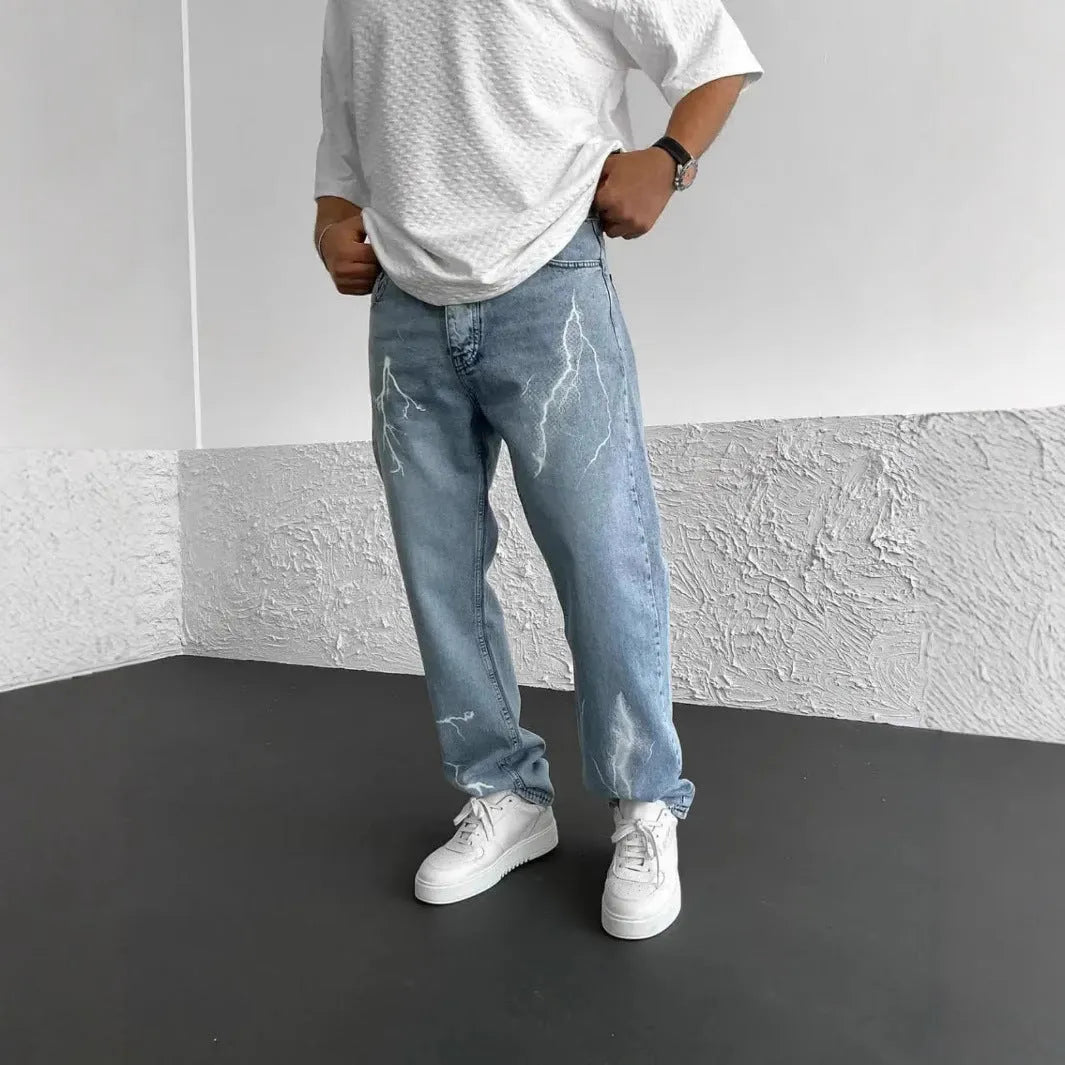 Men's blue straight-leg jeans with a loose wide-leg cut and printed design.