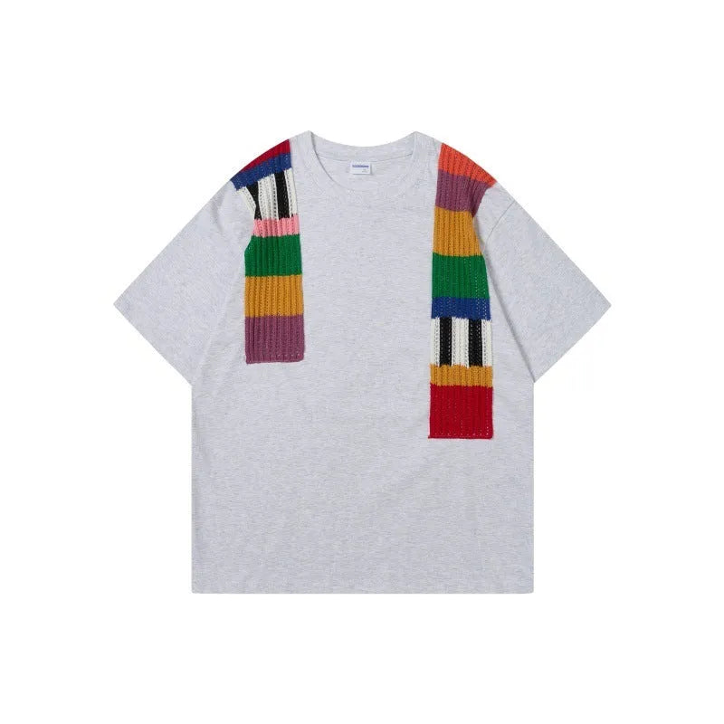 Cotton pullover with patchwork design showing letter patterns in loose fitting short sleeve style