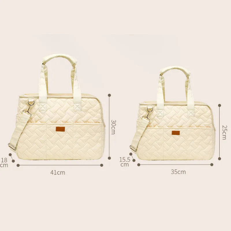 Grey pet carrier handbag with mesh panels showing cat inside, multiple pockets visible on exterior