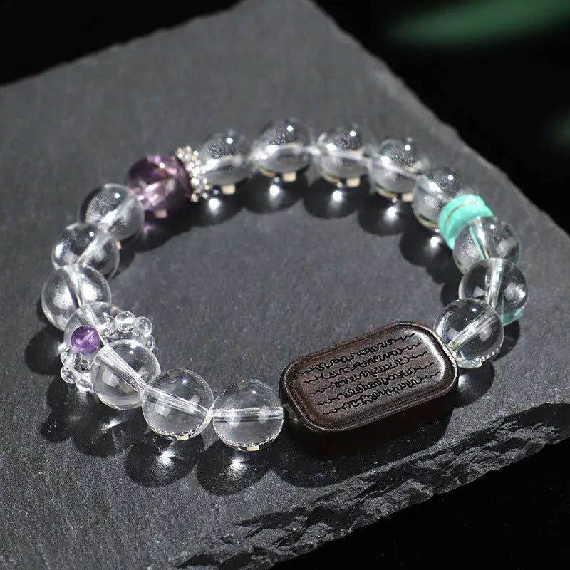 Natural white crystal ebony five warp bracelet on wrist showing wooden beads and ethnic design