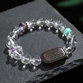 Natural white crystal ebony five warp bracelet on wrist showing wooden beads and ethnic design