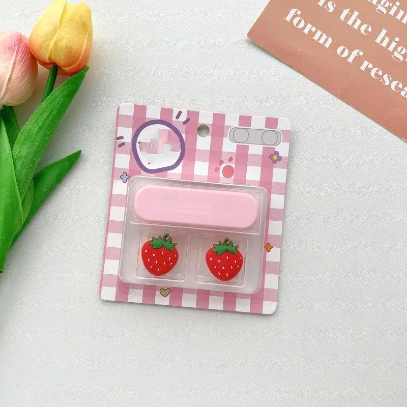 Cartoon-style magnetic plastic cable fixer clip in various colours on a metallic desk surface.