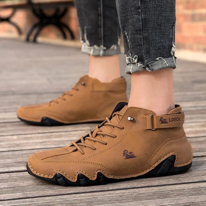 High top men's shoes in khaki with rubber soles and microfiber uppers, showing round toe and pigskin boot tube