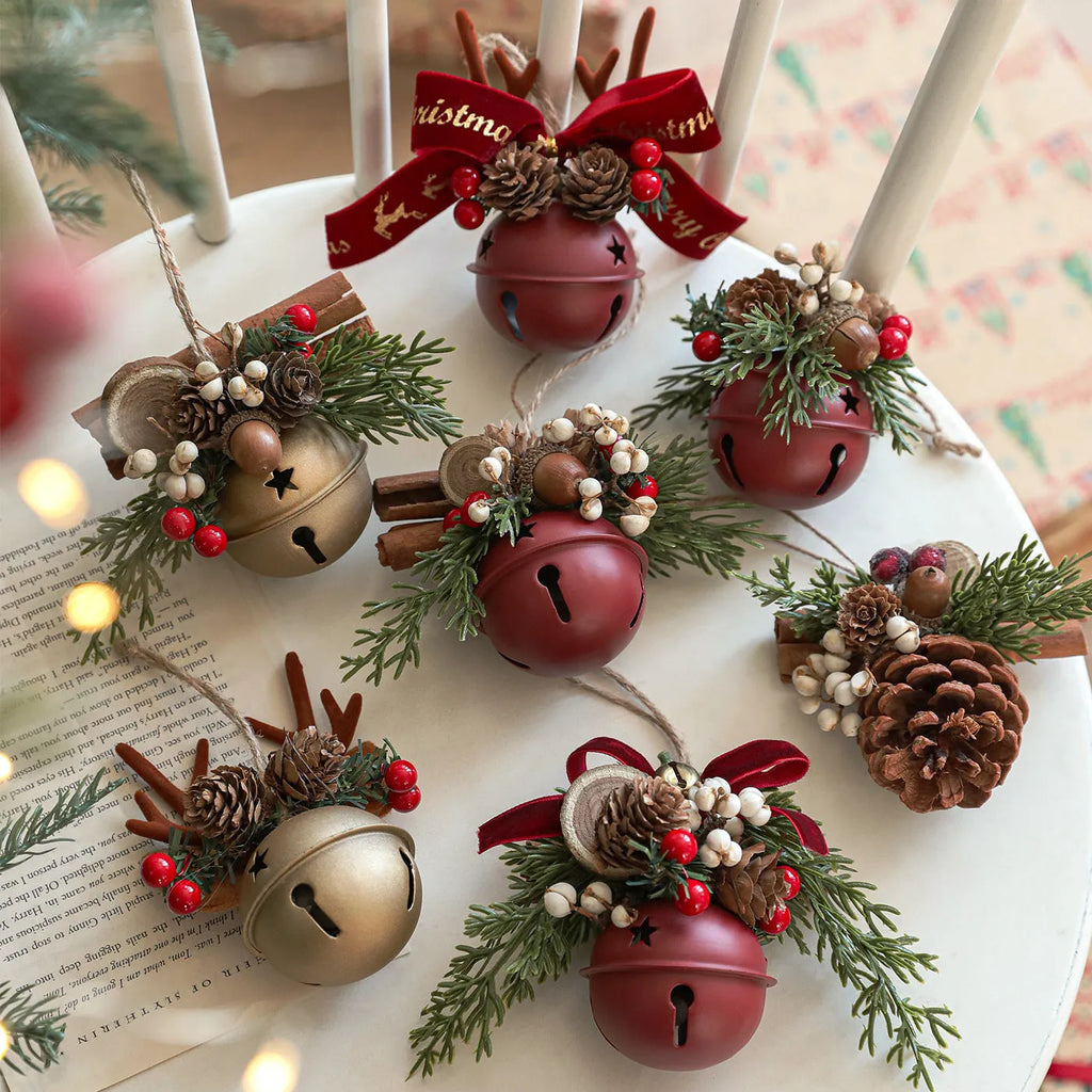 Wrought iron window hanging ornament with a jingling bell, antlers, and pine cone design in a choice of colours.
