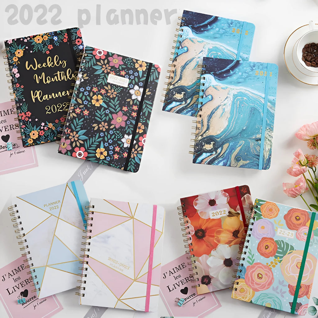 A5 spiral notebook with floral cover design, open to show 100g paper and spiral binding