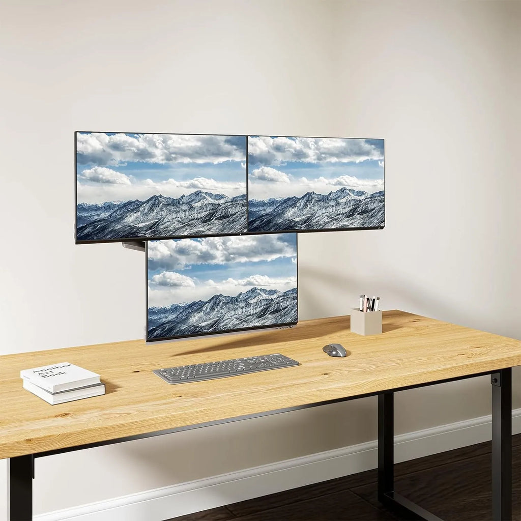 Black three-arm gas spring monitor mount holding 27-inch screen with 360-degree rotation capability
