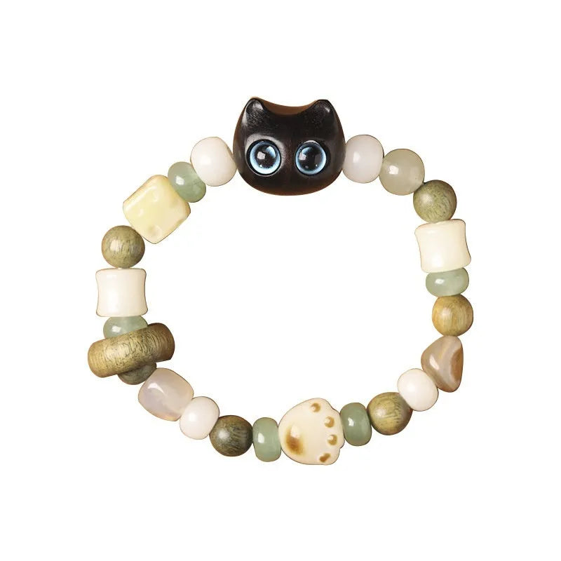 Hand-woven beaded bracelet with a cat's paw charm, multi-treasure cube, and mix of jade and wood beads.