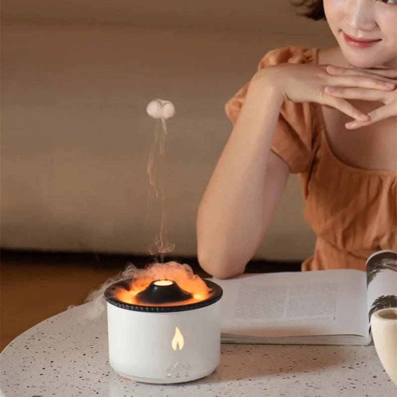 Round white volcano-shaped humidifier with water tank and single fog outlet on wooden surface