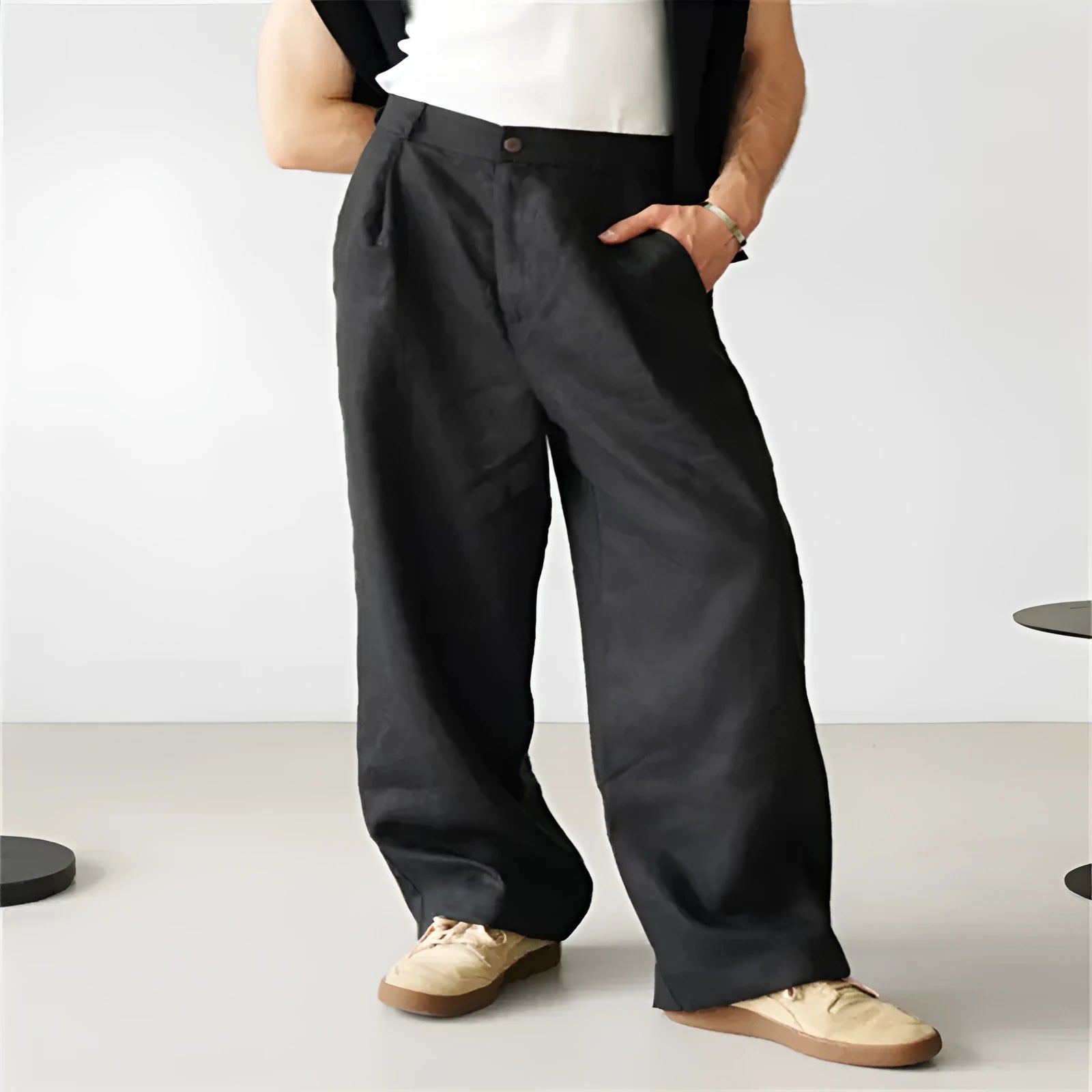 Men's loose high-waisted linen pleated jogger pants in a neutral colour on a hanger.