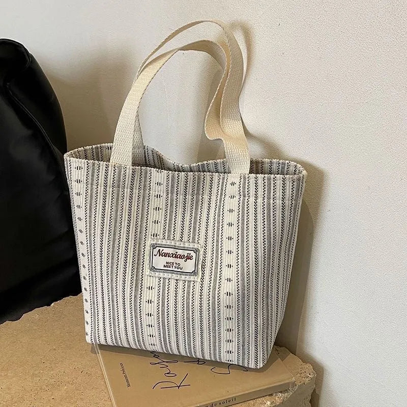 Japanese style large capacity corduroy handbag in dark brown, shown front view.