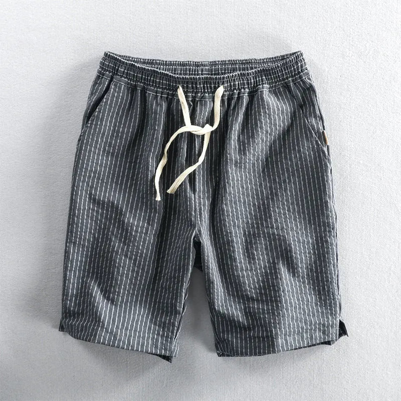 Men's striped cotton shorts with micro-elastic waistband in turmeric colour, showing loose straight fit and mid-waist design