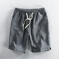 Men's striped cotton shorts with micro-elastic waistband in turmeric colour, showing loose straight fit and mid-waist design
