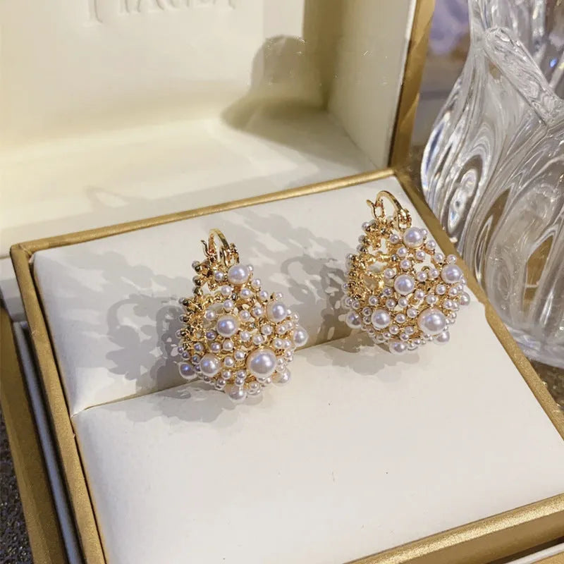 Women's copper flower basket earrings with small rice-shaped beads in gold finish, approximately 3-4 cm diameter