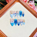 Blue hand-painted carved fake nails with summer ice patterns, transparent sections showing natural nails, four size options displayed