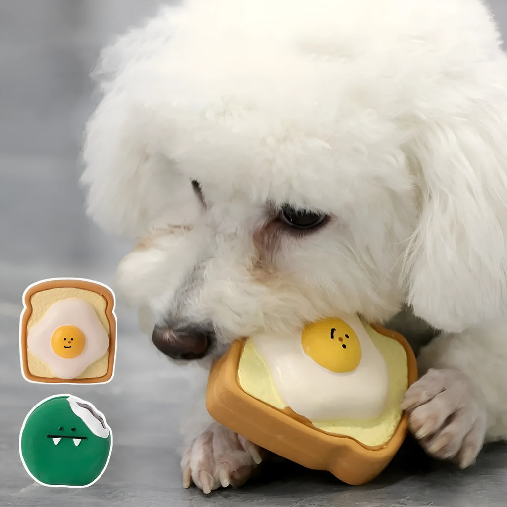 Yellow and green latex dog chew toy shaped like an egg bread with a cartoon puppy pattern.