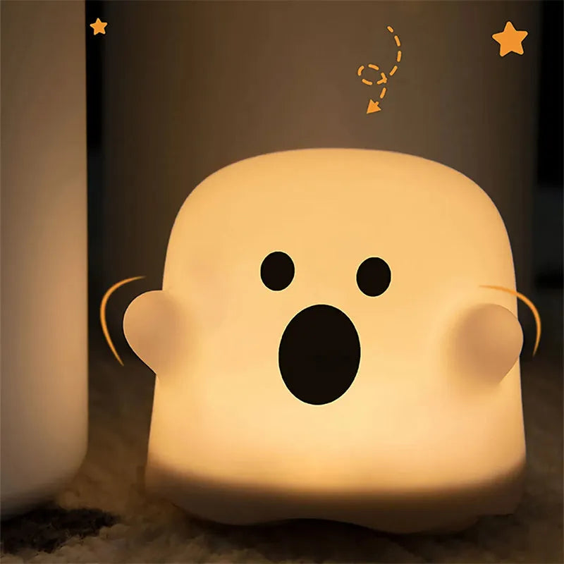 White silicone touch sensor LED night light on a bedside table.