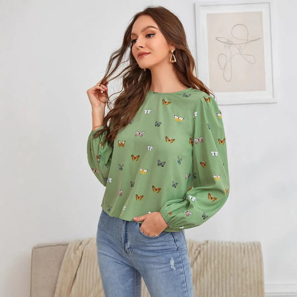 Women's butterfly print long-sleeved shirt in green colour showing loose fit and regular sleeves