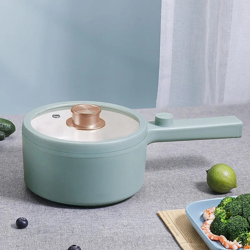 White or green portable electric hot pot cooker with multi-function controls on a countertop.