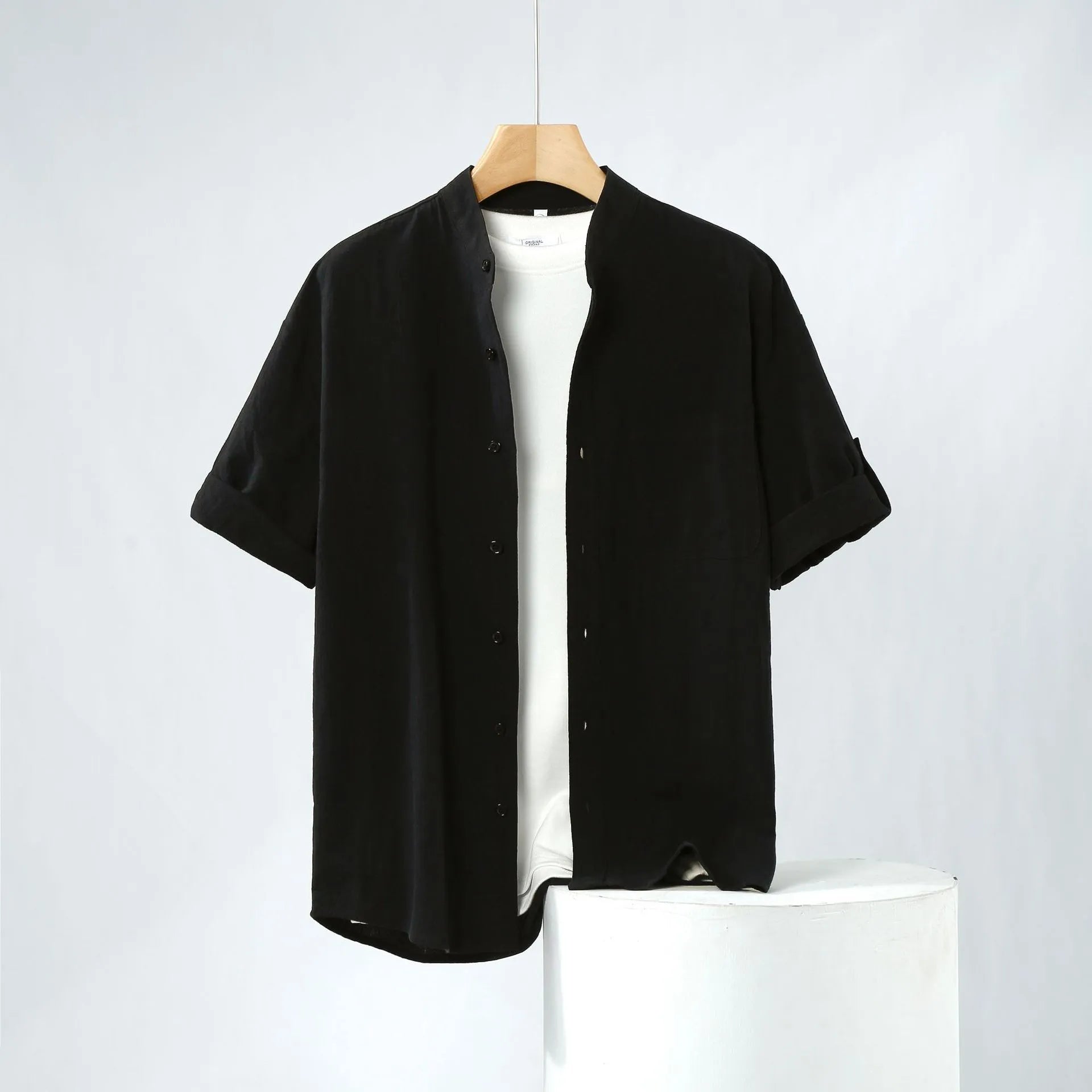 Men's loose fit linen short-sleeve shirt in a solid colour with a simple stand collar.