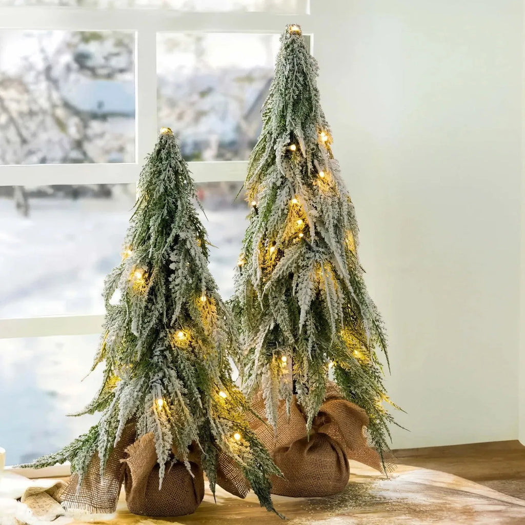 24-inch desktop Christmas tree with PE snow simulation and integrated lighting on wooden surface