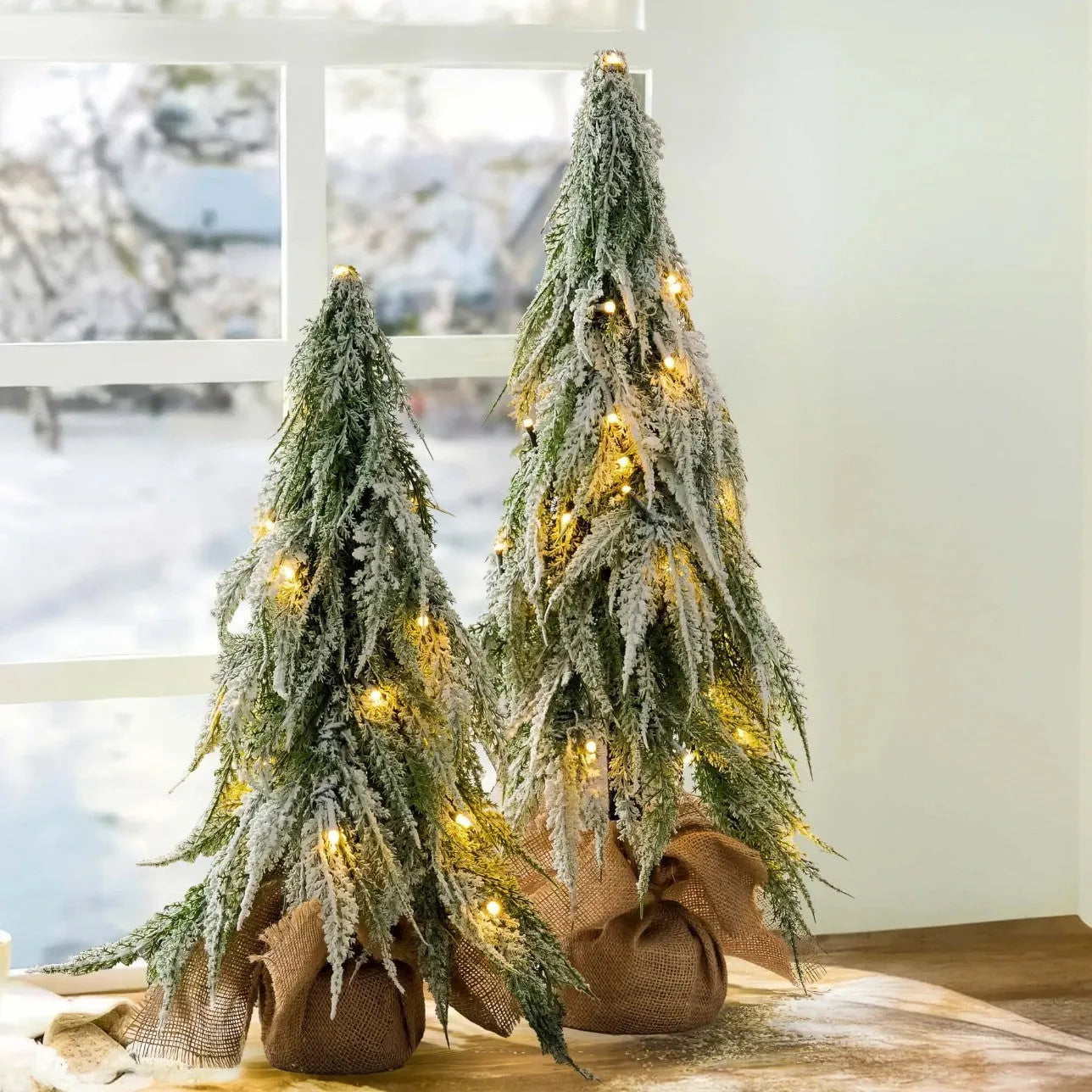 24-inch desktop Christmas tree with PE snow simulation and integrated lighting on wooden surface